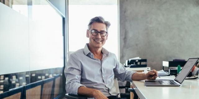 Man smiling while taking break at desk