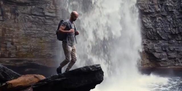 Backpacker by a waterfall