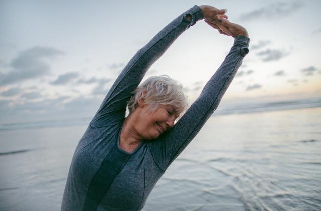 close_up_of_mature_lady_stretching_on_beach.jpg