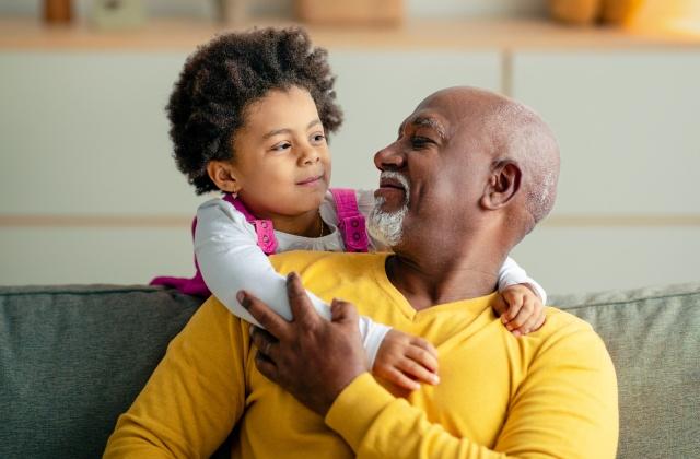 granddad_and_grand-daughter_hugging_on_sofa.jpg